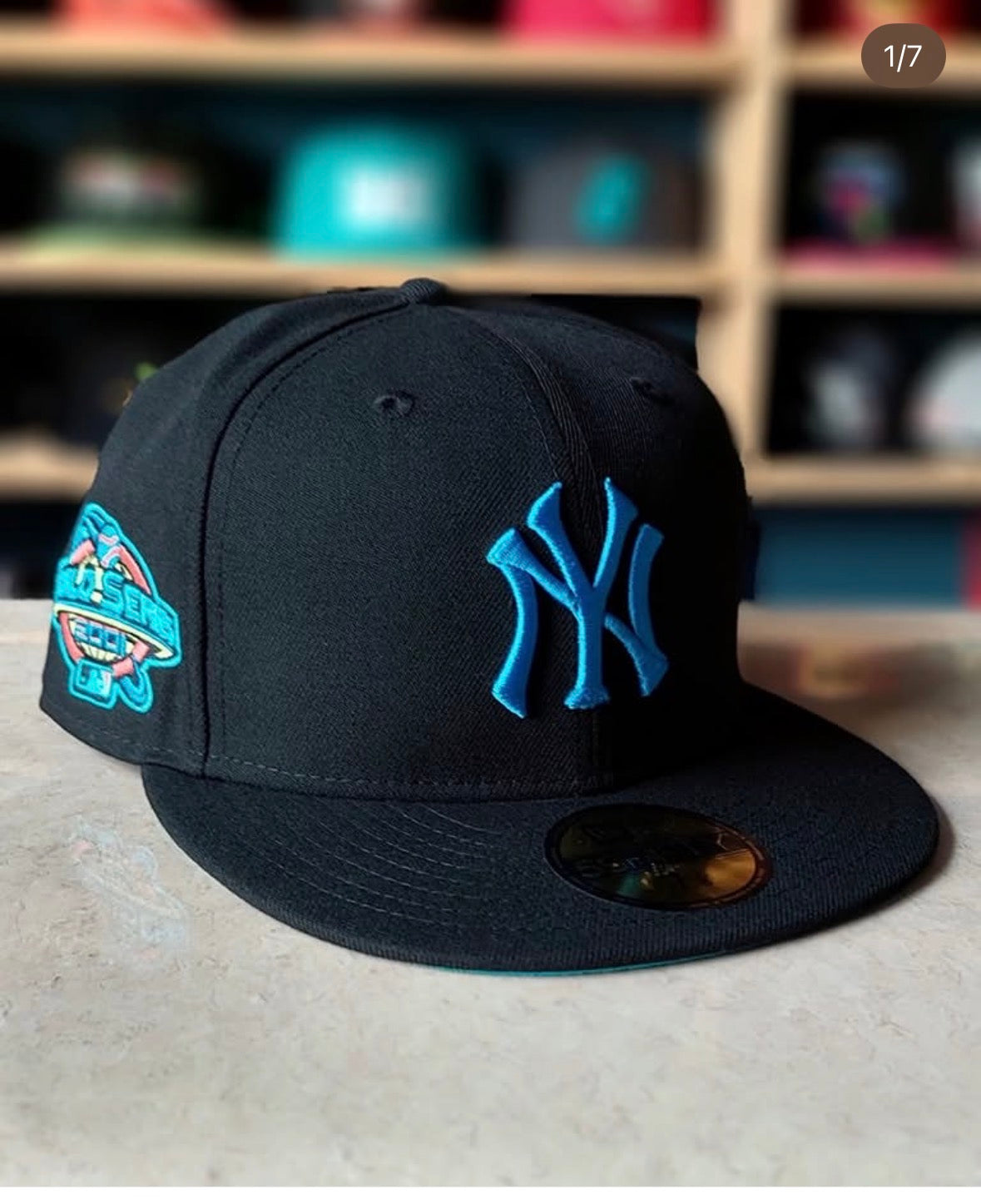 New Era 59FIFTY fitted hat features the New York Yankees logo in a vibrant teal blue embroidery against a black crown