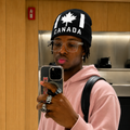 black knit beanie features a white pixelated maple leaf and "CANADA" text in a blocky font.