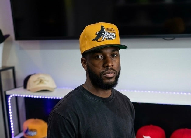vintage-style Tampa Bay Devil Rays snapback cap in yellow with a vibrant logo.