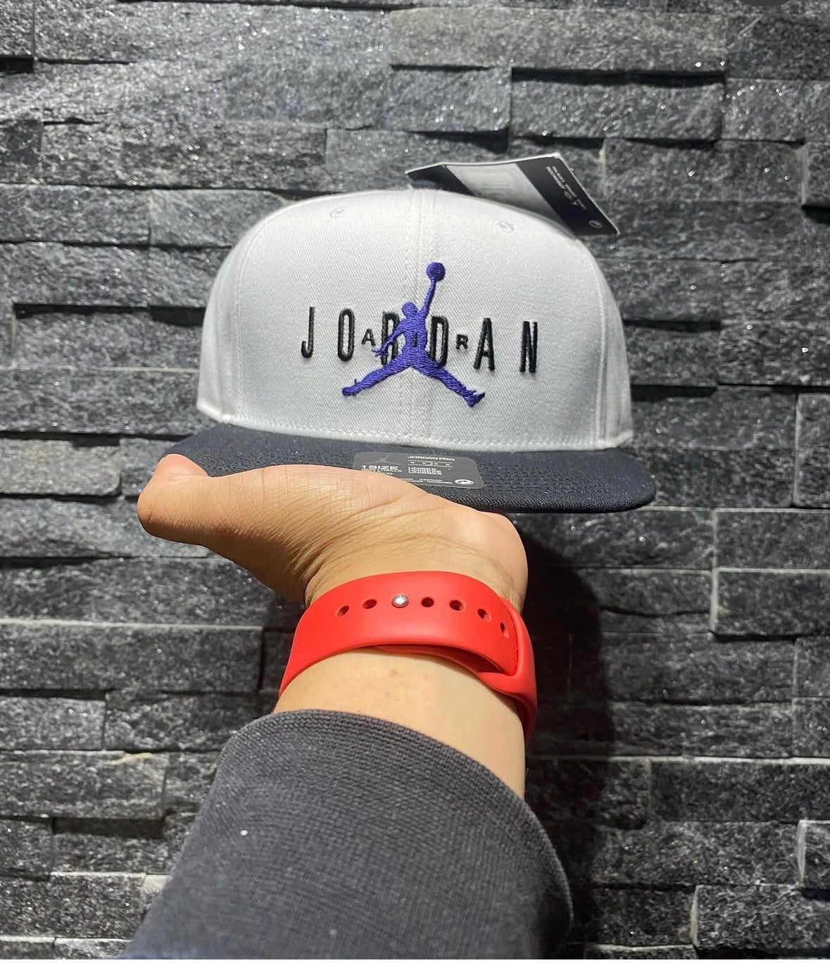 white and black Jordan Pro Jumpman snapback hat featuring a purple embroidered logo.