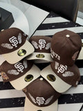 New Era San Francisco Giants "Team Wings" 59FIFTY fitted caps featuring a brown structured crown, a contrast-color brim, and embroidered wings framing the Giants logo