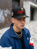 black New Era 59Fifty fitted cap featuring a red Dodgers script logo and a side patch.