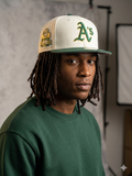 New Era Oakland Athletics 40th anniversary 59FIFTY fitted hat with a stone-colored crown and green visor.