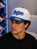 white and blue Mitchell & Ness Los Angeles Dodgers Cooperstown Collection Evergreen snapback features a structured crown and embroidered script logo