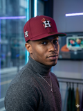 maroon New Era Houston Astros cap features a unique flaming "H" logo on the front and stars on the side