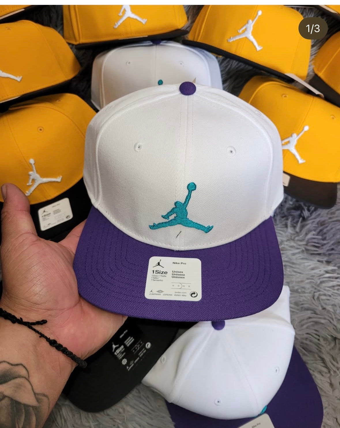 white and purple Jordan Pro Jumpman Snapback cap with a teal embroidered logo.