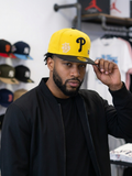 Philadelphia Phillies New Era 59FIFTY fitted hat featuring a yellow crown, black visor, and special side patches.
