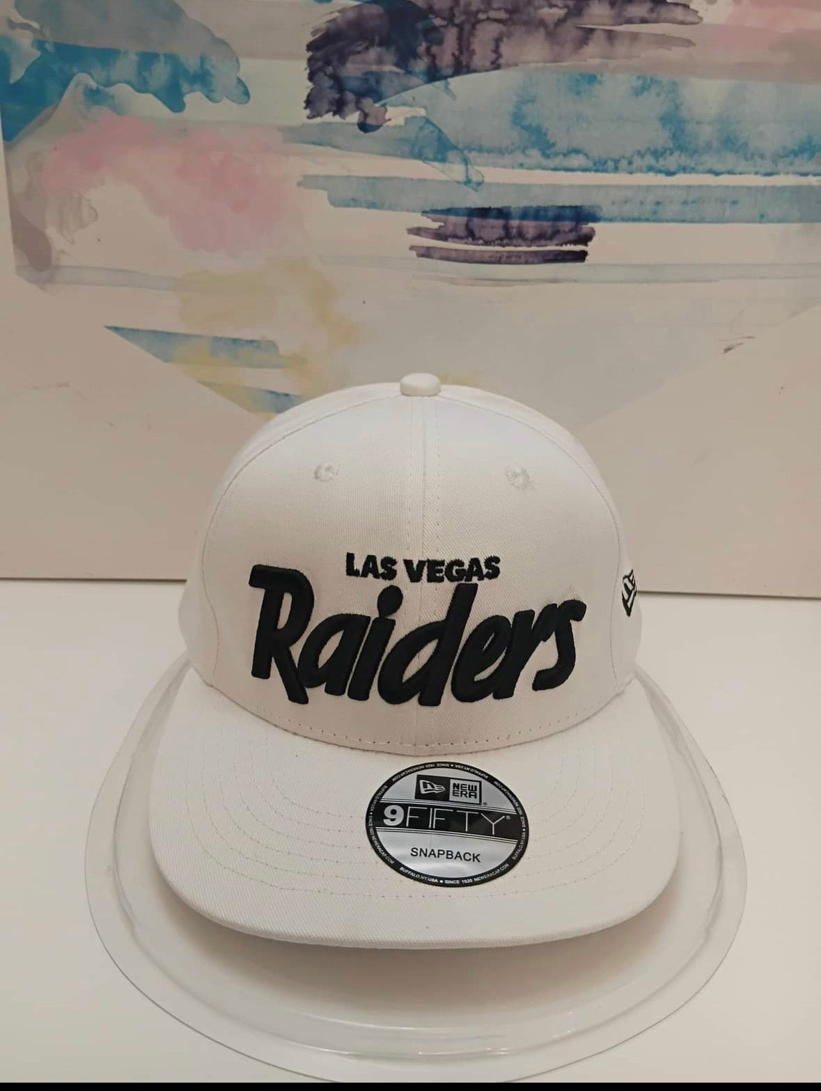 New Era Las Vegas Raiders 9FIFTY snapback hat in white featuring a black script logo.