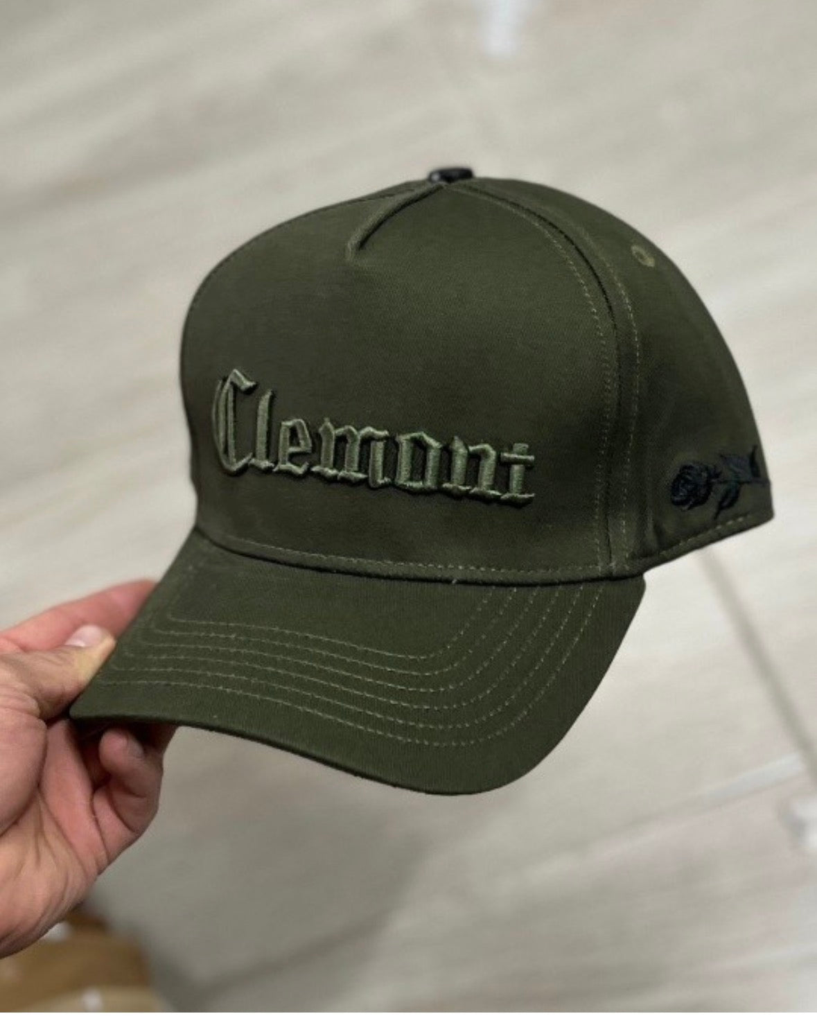 dark green baseball cap is from the brand Clemont