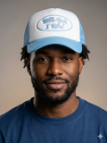 trucker hat featuring a light blue brim, white front panel, and blue embroidery reading "With God I Win!"