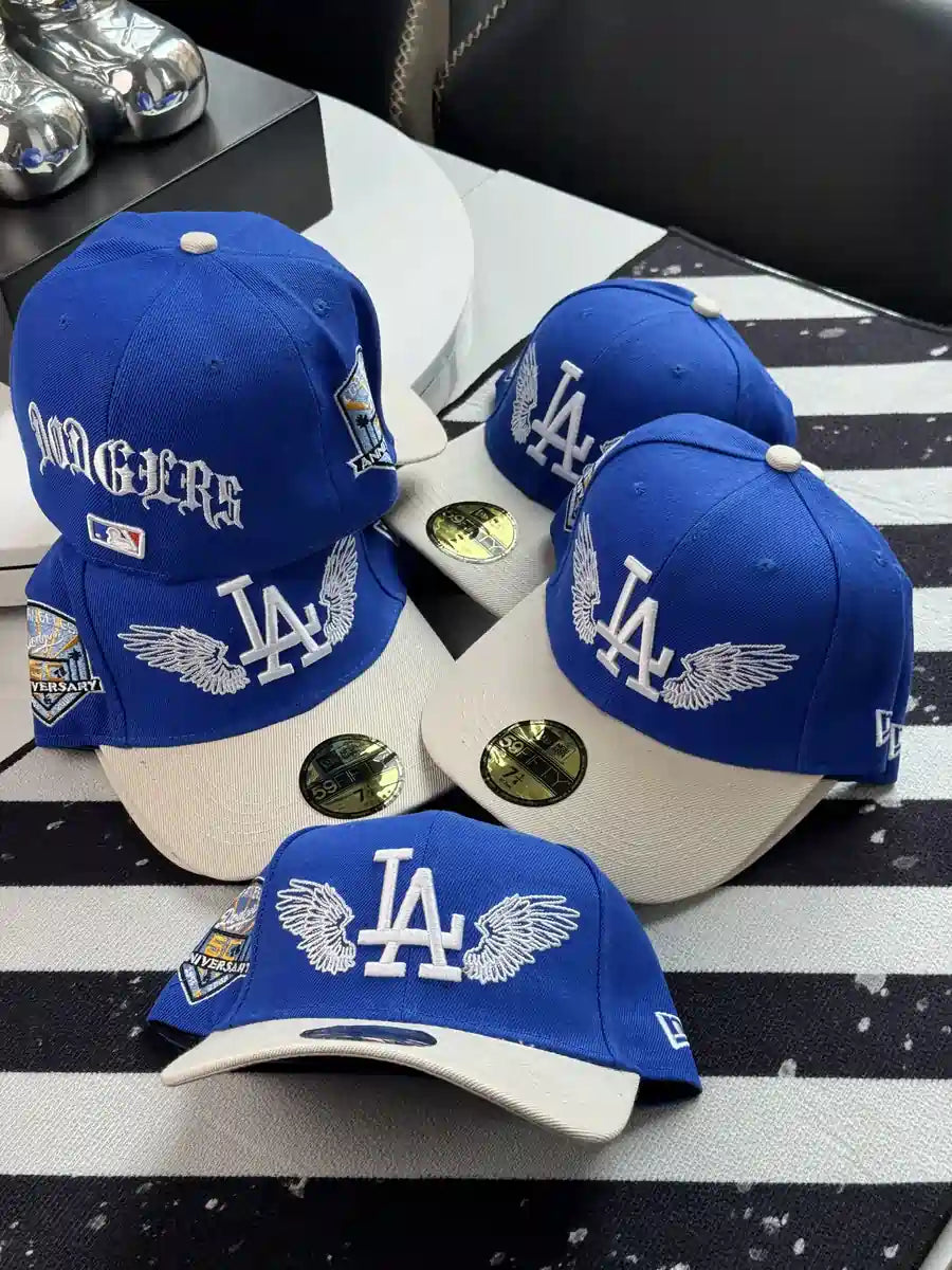 New Era Los Angeles Dodgers "Team Wings" 59FIFTY fitted caps feature embroidered angel wings flanking the team logo.