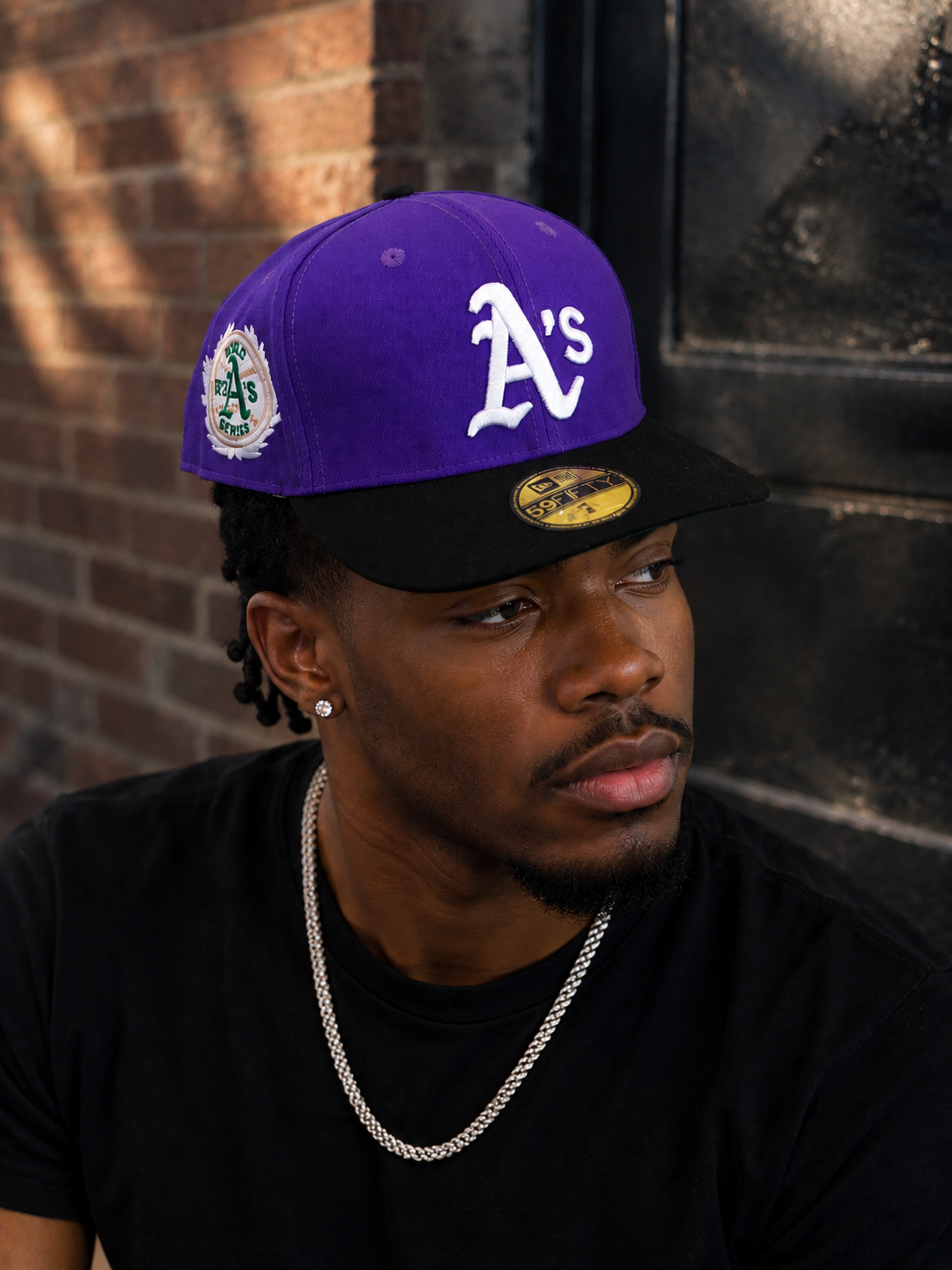 New Era 59FIFTY fitted hat features a distinct purple crown and black brim with a prominent embroidered white Oakland Athletics logo.