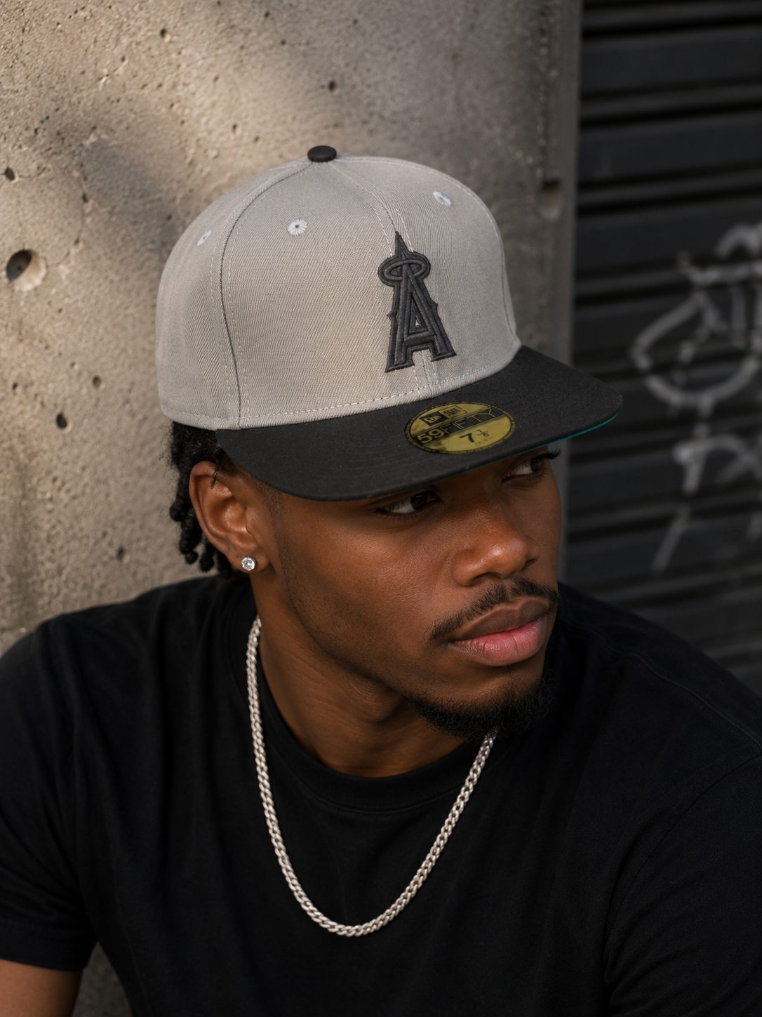 New Era Los Angeles Angels 59FIFTY Fitted Hat with a stone-colored crown, a black visor, and a black embroidered Angels logo on the front.