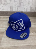 royal blue DC Shoes snapback baseball cap featuring a large, embroidered white logo on the front.