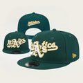 green New Era 9FIFTY snapback hat featuring an embroidered "Athletics" script logo in white and yellow